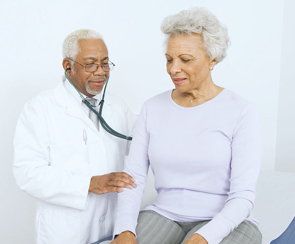doctor checking the heart rate of senior woman