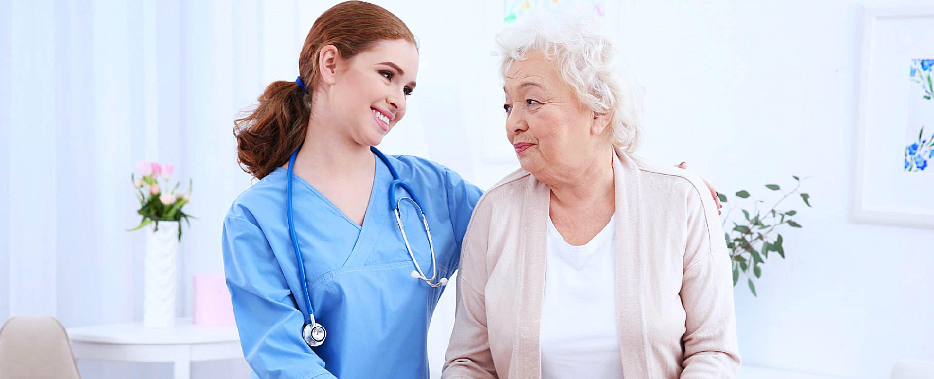 caregiver and senior woman looking at each other