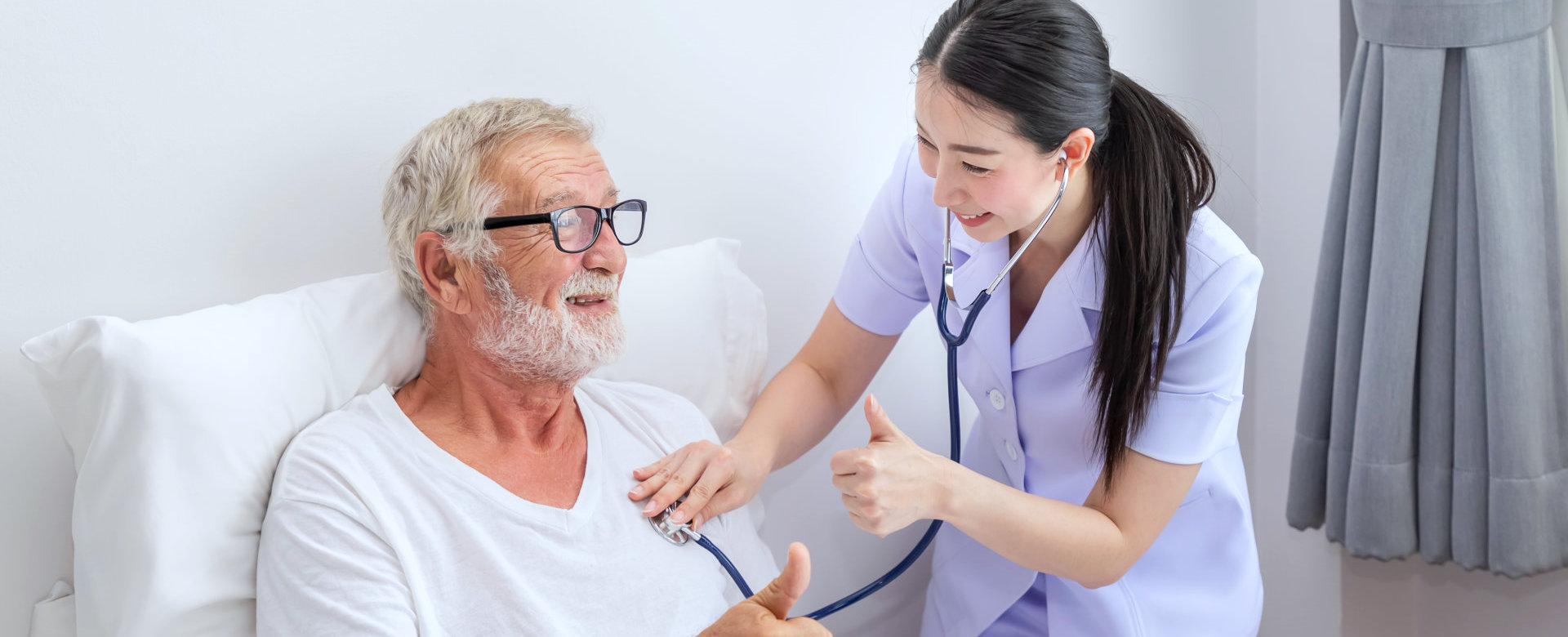 caregiver checking the heart rate of senior man