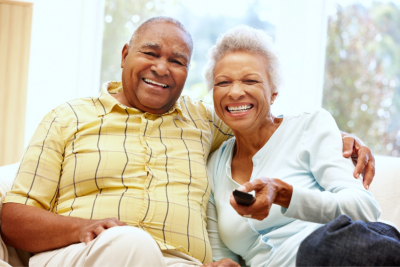 senior woman and caregiver smiling