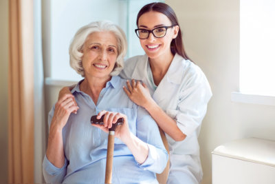 caregiver and senior woman smiling